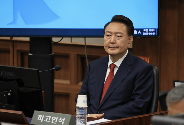 12·3 비상계엄을 선포해 내란 우두머리 혐의로 재판에 넘겨진 윤석열 전 대통령이 21일 오전 서울 서초구 서울중앙지법 417호 법정에 앉아 재판 시작을 기다리고 있다. 뉴시스