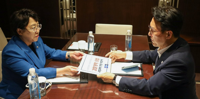 김선민(왼쪽) 조국혁신당 대표 권한대행이 지난 10일 서울 모처에서 김민석 국무총리를 만나 ‘검찰개혁 입법 국정과제 반영 제안서’를 전달하고 있다. 연합뉴스