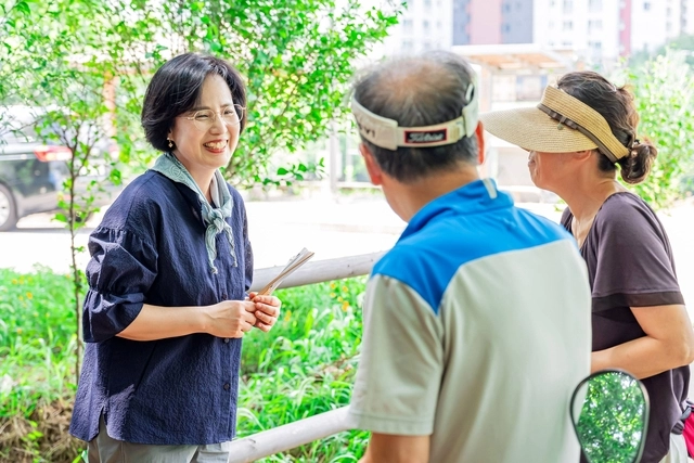 이수희(왼쪽) 서울 강동구청장이 ‘강동 한강그린웨이’ 일부 구간인 고덕산 현장을 방문해 주민들과 인사를 나누고 있다.  강동구청 제공