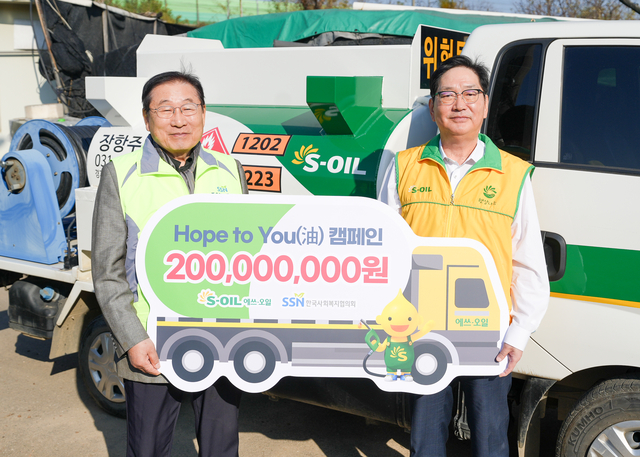 서정규(오른쪽) 에쓰오일 본부장과 김성이 한국사회복지협의회 회장이 기념촬영을 하고 있다. 에쓰오일 제공