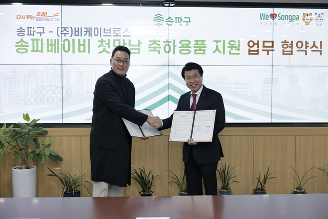 서강석(오른쪽) 송파구청장과 서동희 타가 대표가 협약서를 교환하며 악수하고 있다. 송파구 제공