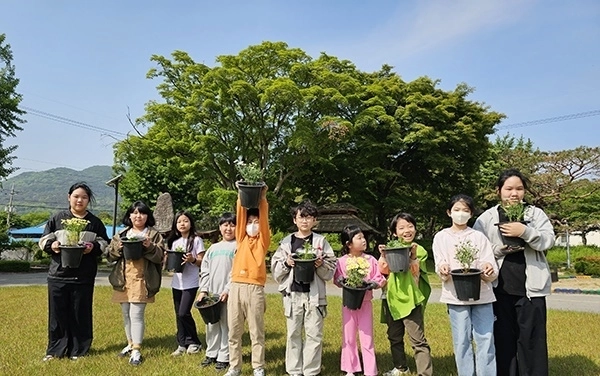 학생 수 감소로 분교 전환 위기에 몰린 충남 예산군 대흥초등학교 학생들이 저마다 화분을 하나씩 들고 활짝 웃고 있다. 대흥초등학교 제공