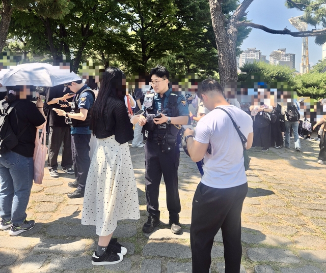BTS 부산 공연장 근처에서 암표를 파려던 여성이 경찰에 붙잡혀 조사를 받고 있다. 부산경찰청 제공