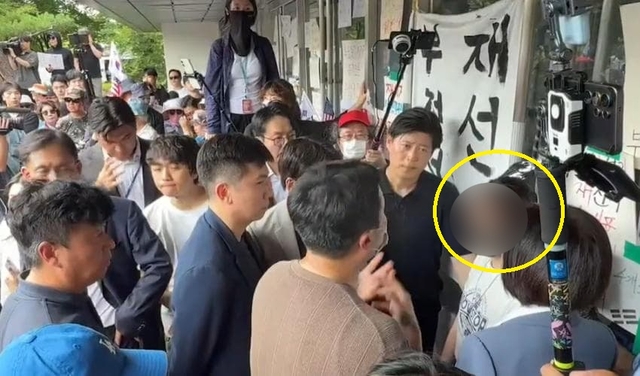 체육회 관계자들의 핸드볼경기장 진입을 막고 있는 여성. 인터넷 커뮤니티