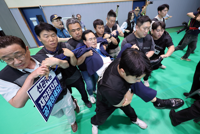 15일 오후 충북 충주시장 당선무효 소청과 관련한 재검표가 진행된 국립한국교통대학교 다목적 강당에서 더불어민주당 맹정섭 후보가 강제 퇴거 조치 당하고 있다. 연합뉴스