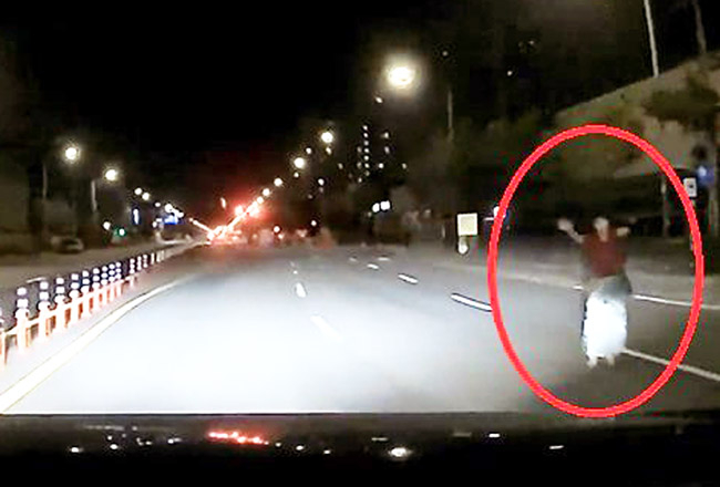 “의도적?” 한밤중 도로 한복판 ‘두팔 든 여자’
