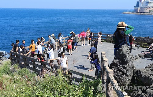 (제주=연합뉴스) 중국인 관광객(유커)들이 28일 제주시 용두암 부근을 찾아 해안 전망을 감상하고 있다. 중국 중추절과 국경절로 이어지는 황금연휴를 맞아 많은 중국인 관광객이 제주를 찾고 있다.