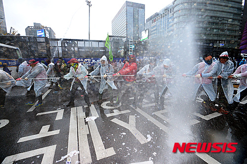 14일 오후 서울 중구 시청 서울광장에서 민중총궐기대회를 마친 참가자들이 경찰버스를 끌어내려 하자 경찰이 캡사이신을 섞은 물대포를 쏘고 있다. 민주노총, 전농 등 참가단체들은 집회에서 정부가 추진하는 노동개혁과 역사 교과서 국정화 정책을 규탄하고 청년실업, 쌀값 폭락, 빈민 문제 등의 해결책 마련을 요구할 예정이다.