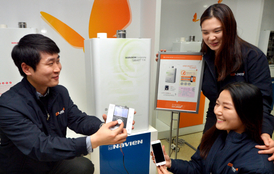 경동나비엔 직원들이 지난 11일 서울 영등포구 여의동 사옥에서 업계 최초로 사물인터넷(IoT) 기술을 접목한 스마트폰 원격제어 보일러 ‘나비엔 콘덴싱 스마트 톡(TOK)’의 휴대전화 연계 서비스를 시연하고 있다.