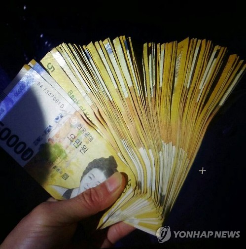 (부산=연합뉴스) 지난 3일 오전 11시 10분께 부산 영도구 봉래시장 앞 도로에서 분실한 5만원권 100장 가운데 순찰 중이던 경찰이 수거한 97장. 부산 대교파출소