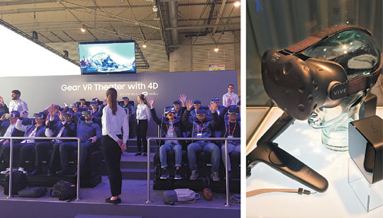 22일(현지시간) ‘모바일월드콩그레스(MWC) 2016’이 열린 스페인 바르셀로나 피라그란비아 3번 홀의 삼성전자 전시관에 마련된 가상현실(VR) 기기 ‘기어VR’ 체험 스튜디오에서 관람객들이 VR 롤러코스터를 즐기고 있다. 오른쪽 사진은 7번 홀에 마련된 대만 업체 HTC의 전시관에 전시된 VR 기기 ‘바이브’. 임정환 기자