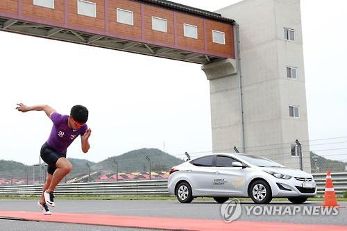 (영암=연합뉴스) 5일 오후 전남 영암 F1 경주장에서 대한민국 100m 기록을 보유한 육상 단거리 국가대표 김국영 선수와 프로 카레이서 권봄이가 운전하는 아반떼 승용차가 70m 경주를 펼치고 있다.
