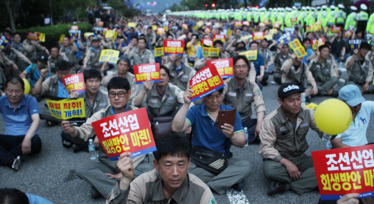 15일 경남 창원시 의창구 성산아트홀 앞 도로에서 전국금속노조 경남지부 소속 조합원 5000여 명이 정부의 조선업 회생 방안 마련, 구조조정 철회 등을 요구하는 집회를 열고 있다.  연합뉴스