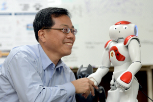 장병탁 교수가 로봇 ‘나오’에게 말을 건네며 악수하고 있다. ‘나오’는 일본 소프트뱅크가 지난 2012년 인수한 프랑스 로봇 전문기업 알데바란 로보틱스가 만든 휴머노이드다.