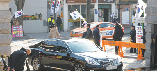 박근혜 대통령 탄핵심판 선고가 임박한 가운데 3일 서울 종로구 재동 헌법재판소 정문에서 헌법재판관들이 출근하는 차량 뒤로 탄핵 기각을 촉구하는 1인 시위가 곳곳에서 벌어지고 있다.