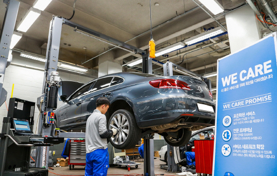 폭스바겐 서비스센터 직원이 ‘위 케어 캠페인’의 하나로 입고된 차량 유지 보수 서비스를 하고 있다.  폭스바겐코리아 제공