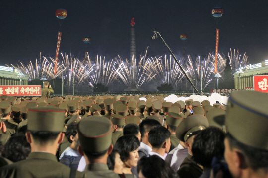 6일 북한 평양 김일성 광장에서 군인과 주민들이 모여 대륙간탄도미사일(ICBM) 화성-14형 시험발사 성공을 축하하는 불꽃놀이 행사를 지켜보고 있다.
