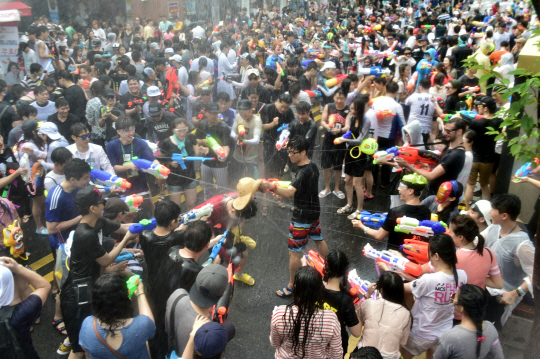 지난해 7월 서울 서대문구 연세로에서 열린 ‘신촌물총축제’에 참가한 시민들이 상대편에게 물총을 쏘며 축제를 즐기고 있다.