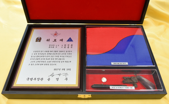 만년필, 구두 주걱이 달린 열쇠고리, 단추 등 한진홍 일병 유품과 국방부 장관 위로패, 유해 수습 시 관을 덮은 태극기 등이 담긴‘호국의 얼 함’.  국방부 제공