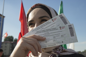 히잡 차림의 여성이 11일 오전(한국시간) 이집트축구대표팀의 훈련을 지켜보기 위해 러시아 그로즈니의 아흐마트아레나 앞에서 입장권을 꺼내고 있다. Tass통신 연합뉴스