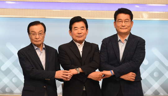 더불어민주당 당 대표 경선에 출마한 이해찬(왼쪽부터)·김진표·송영길 의원이 6일 오전 대전 MBC에서 열린 충청권역 TV토론회에 앞서 손을 잡고 포즈를 취하고 있다.  연합뉴스