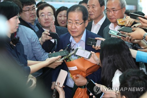 (영종도=연합뉴스) 휴식을 위해 미국으로 출국하는 홍준표 자유한국당 전 대표가 11일 오후 인천공항에 서 기자들과 질의응답을 마친 뒤 출국장으로 향하고 있다. 2018.7.11