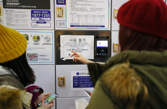 KT 아현지사 화재로 통신 장애가 계속된 26일 서울 마포구 지하철 2호선 홍대입구역에서 물품보관소를 이용하려던 홍콩 관광객들이 난감해하고 있다.  연합뉴스