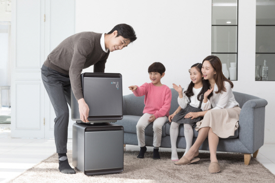 삼성전자 모델들이 공기청정기 ‘삼성 큐브’를 분리·결합하면서 살펴보고 있다.  삼성전자 제공