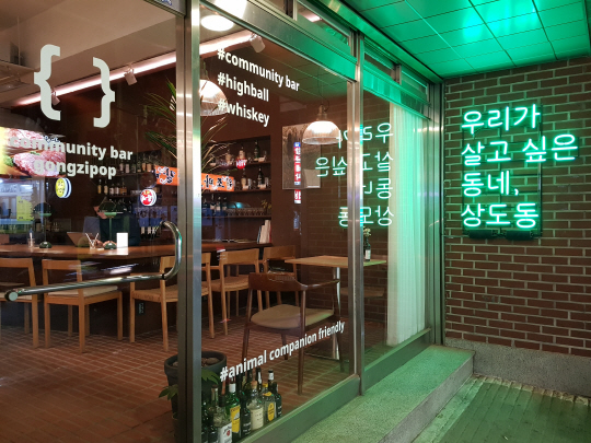 서울 동작구 상도동에 자리잡은 커뮤니티 바 ‘공집합’. 큰 창과 글씨들이 소통을 위해 유리창을 장식하고 있다
