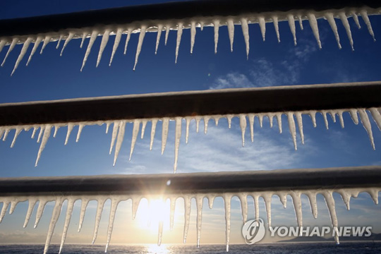 (강릉=연합뉴스) 올겨울 들어 가장 추운 날씨를 보인 28일 오전 강원 강릉시 해변 도로 가드레일에 바닷물이 얼어붙으면서 생겨난 고드름이 주렁주렁 달려 있다. 2018.12.28