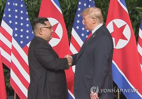 (서울=연합뉴스) 첫 북미정상회담이 열린 지난해 6월 12일 싱가포르 센토사 섬 카펠라호텔에서 미국 도널드 트럼프 대통령과 북한 김정은 국무위원장이 북미정상회담에 앞서 악수하고 있는 모습. 2019.2.19 [연합뉴스 자료사진]