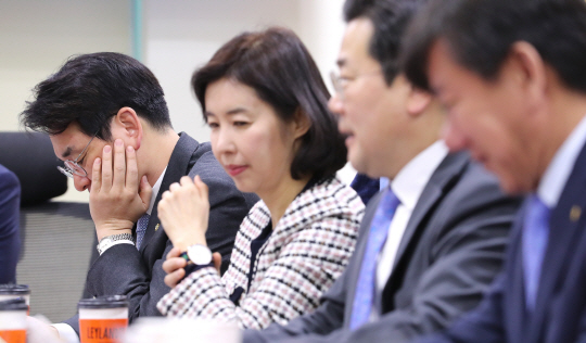 사립유치원 개혁을 주도해 온 박용진(왼쪽) 더불어민주당 의원이 7일 오전 국회 의원회관에서 열린 당 ‘유치원·어린이집 공공성 강화 특별위원회’ 회의에서 턱을 괸 채 자료를 들여다보고 있다.  연합뉴스