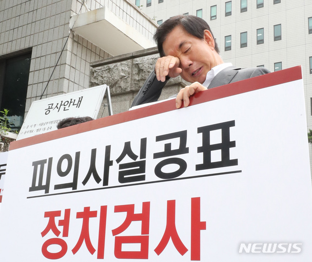 【서울=뉴시스】 ‘딸 부정채용 의혹’을 받는 김성태 자유한국당 의원이 자신을 뇌물수수 혐의로 기소한 서울남부지검 앞에서 지난 23일 오전 억울함을 호소하는 1인 시위 중 눈물을 훔치고 있다. 2019.07.23.