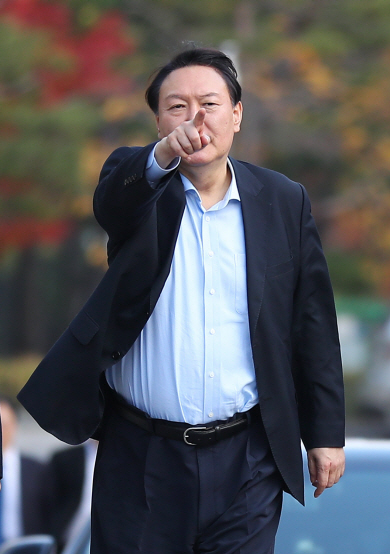 윤석열 검찰총장이 조국 전 법무부 장관의 아내 정경심 동양대 교수를 업무상 횡령 등 14개 혐의로 기소한 11일, 서울 서초구 대검찰청에서 점심식사를 마친 후 산책을 하며 손으로 어딘가를 가리키고 있다.  뉴시스