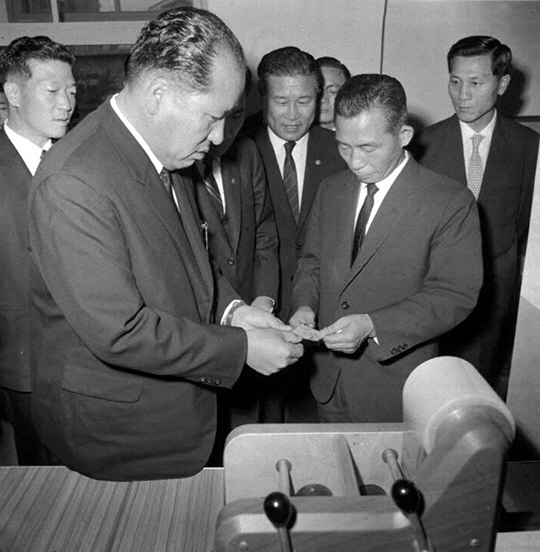 1968년 11월 21일 당시 박정희(오른쪽) 대통령이 서울 종로구 자하동사무소에서 대한민국 1호로 발급된 주민등록증을 받고 있다.  국가기록원