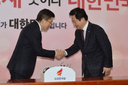 황교안(왼쪽) 자유한국당 대표와 원희룡 제주지사가 22일 오전 중도·보수통합 신당 문제를 논의하기 위해 국회 당 대표실에서 만나 악수하고 있다.