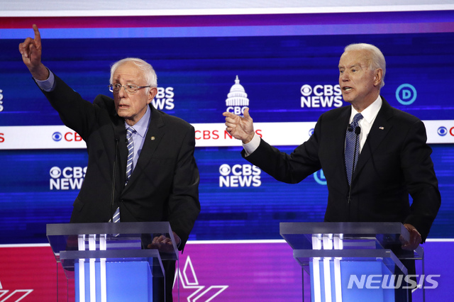 [찰스턴=AP/뉴시스] 25일(현지시간) 미국 사우스캐롤라이나주 찰스턴에서 열린 민주당 대선 경선 후보 TV토론회에서 버니 샌더스 상원의원(왼쪽)과 조 바이든 전 부통령이 발언권을 놓고 신경전을 벌이고 있다.