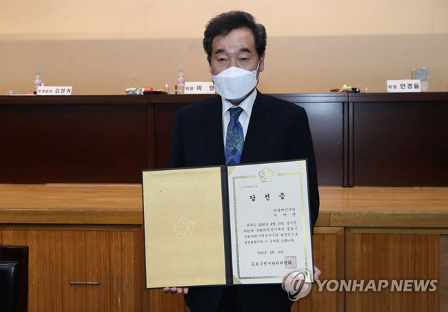 (서울=연합뉴스) 21대 총선 서울 종로에서 당선된 더불어민주당 이낙연 코로나19국난극복대책위원장이 16일 새벽 개표소가 마련된 서울 종로구 경복고등학교에서 종로구선거관리위원장으로부터 당선증을 받은 뒤 펼쳐 보이고 있다. 2020.4.16