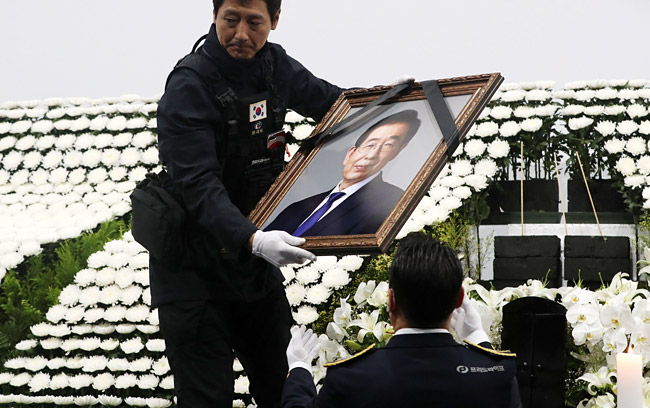 13일 서울 중구 서울광장에 차려졌던 박원순 전 서울시장의 시민분향소가 철거되면서 분향소 관계자가 영정사진을 옮기고 있다. 뉴시스