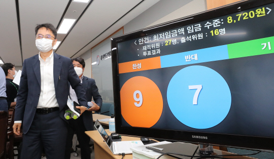 박준식(왼쪽) 최저임금위원장이 14일 새벽 정부세종청사 고용노동부에서 2021년 최저임금이 1.5% 인상된 8720원으로 결정된 제9차 전원회의 결과를 설명한 뒤 회의장을 나서고 있다.  연합뉴스