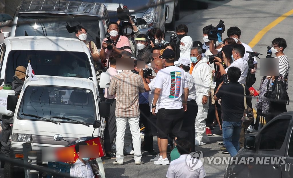 (서울=연합뉴스) 사랑제일교회 관계자 등이 18일 오후 서울 성북구 장위2동 교회 인근 도로에서 민관 합동 방역 요원들과 실랑이를 벌이고 있다. 2020.8.18