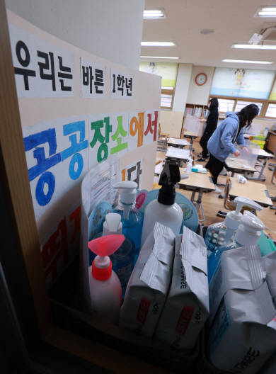 3월 새 학기 개학을 앞둔 25일 오후 서울 서초구 언남초에서 교직원들이 교실 방역을 위해 책상 가림막을 설치하고 있다.  연합뉴스
