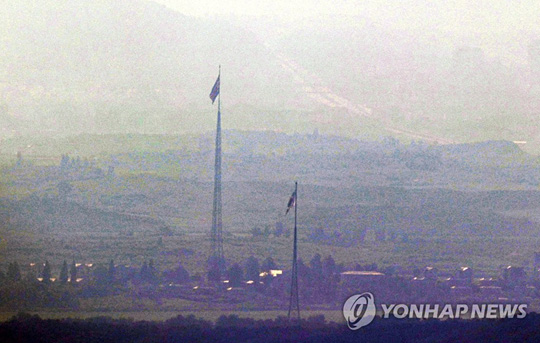 (파주=연합뉴스)27일 경기도 파주시 접경지역에서 바라본 서부전선 비무장지대(DMZ)에 남한 대성동 마을의 태극기와 북한 기정동 마을의 인공기가 펄럭이고 있다.이날 박수현 청와대 국민소통수석은 남북이 오전 10시부터 그동안 단절됐던 남북 간 통신연락선을 전격 복원하기로 했다고 긴급 브리핑을 통해 발표했다. 2021.7.27