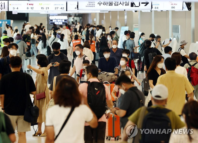(서울=연합뉴스) 윤동진 기자 = 광복절 연휴를 하루 앞둔 13일 오후 김포공항 국내선 청사에서 시민들이 항공권 발권을 위해 이동하고 있다. 2021.8.13