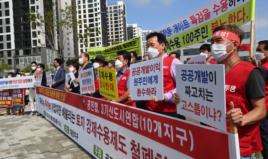 30일 오전 경기 성남시 분당구 대장동에서 공공주택지구 전국연대대책협의회 회원들이 대장동 개발의혹과 관련, 민간업자에게 막대한 이익을 남긴 토지강제수용제도 등을 비판하는 시위를 벌이고 있다.