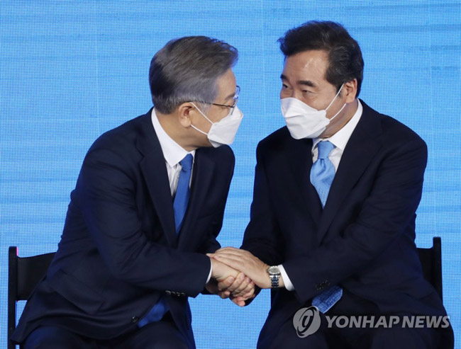 (서울=연합뉴스) 더불어민주당 제20대 대통령 후보에 선출된 이재명 경기도지사가 10일 오후 서울 송파구 올림픽공원 SK올림픽핸드볼경기장에서 열린 서울 합동연설회에서 이낙연 경선 후보의 축하를 받고 있다. 2021.10.10 [국회사진기자단]