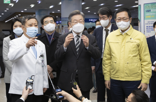 이재명(앞쪽 가운데) 더불어민주당 대선 후보가 6일 인천 동구 인천의료원을 방문해 조승연(〃왼쪽) 원장의 설명을 듣고 있다. 오른쪽은 박남춘 인천시장.  국회사진기자단