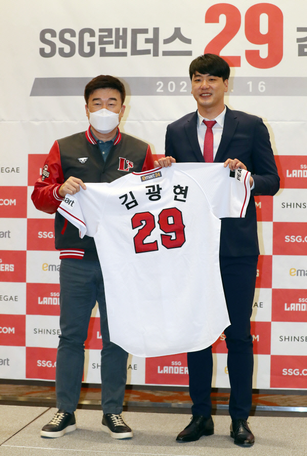 SSG의 김광현(오른쪽)이 16일 오후 인천 오라카이송도파크호텔에서 열린 입단식에서 민경삼 대표이사에게 유니폼을 전달받고 있다. 뉴시스