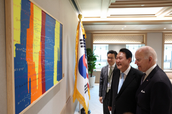 윤석열 대통령이 지난달 21일 용산 대통령실에서 조 바이든 미국 대통령과 단독 환담을 마친 후 벽에 걸린 김현우 작가의 ‘퍼시잭슨 수학드로잉’을 보며 대화하고 있다. 대통령실 제공.