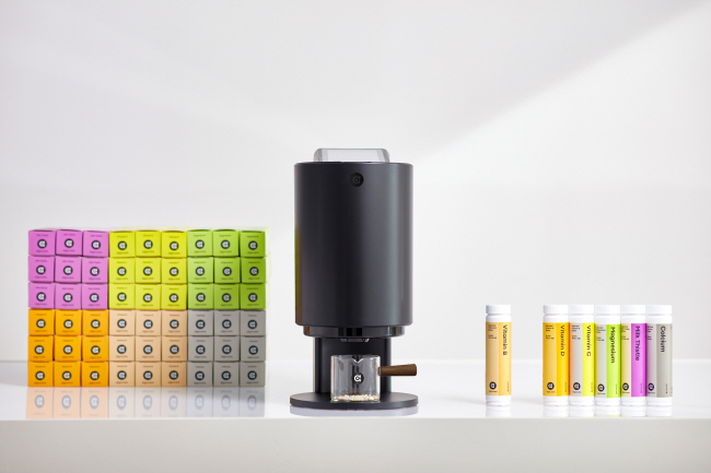 기업 임직원 맞춤형 건강관리 솔루션 ‘알고케어 앳 워크’. 헬스케어 인공지능(AI)과 영양관리 기기인 ‘뉴트리션 엔진’(가운데), 영양제를 담는 ‘뉴트리션 보틀’(오른쪽) 등으로 구성돼 있다.  알고케어 제공